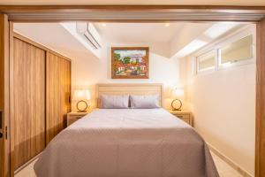 a bedroom with a large bed with two lamps at Harbor NT2505 by Moikkarentals in Puerto Vallarta +60 photos