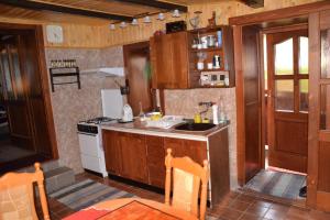 a kitchen with a sink and a stove at Holiday Home V Kolte in Kolta