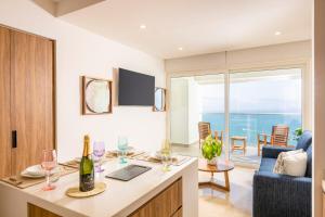 a living room with a table with wine glasses at Harbor NT2505 by Moikkarentals in Puerto Vallarta