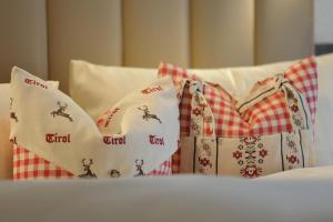 a group of pillows on a bed at Jungmann Apartments in Ischgl