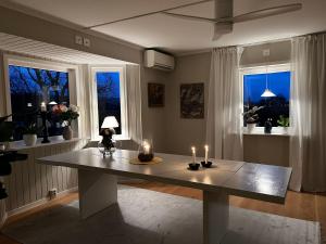 a table with candles on it in a room with windows at 12an i Vånga in Vånga