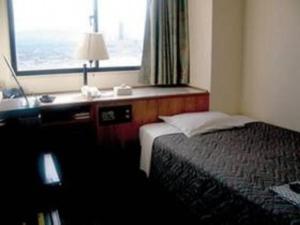 En eller flere senge i et værelse på Nakatsu Sunrise Hotel - Vacation STAY 64653v