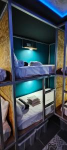 two bunk beds in a room with blue lights at "The Sisters' Hostel" the women only hostel in Adeje