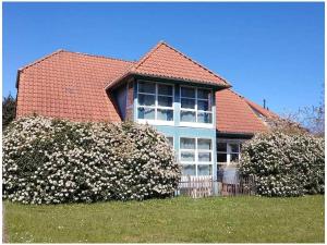 a house with two bushes in front of it at 1-bedroom apartment in Putgarten