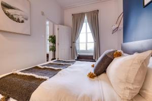 a bedroom with a large bed with pillows on it at North House - Des Remparts- 2-bed with great views, terrace in Quebec City
