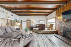 a living room with a couch and a fireplace at Gleneden BeachFront Getaway in Lincoln Beach
