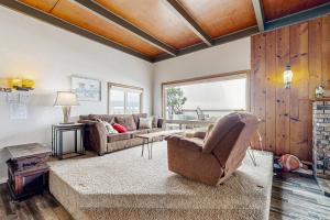 a living room with a couch and a chair at Gleneden BeachFront Getaway in Lincoln Beach