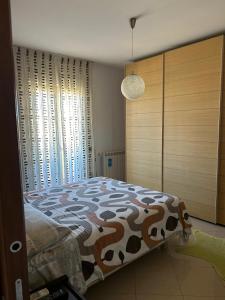 Ένα ή περισσότερα κρεβάτια σε δωμάτιο στο Villa Letizia - Sabaudia