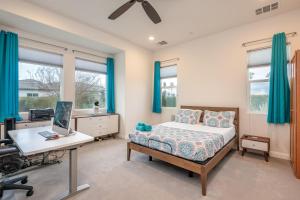 a bedroom with a bed and a desk with a computer at Coachella Dream - Luxury Mid-Term Rental in Indio +37 photos