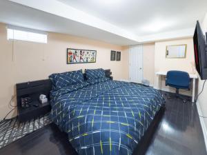 a bedroom with a bed and a desk and a television at Private - Spacious with Jacuzzi and Great Location in Mississauga