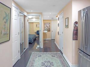 a hallway with a room with a bed and a rug at Private - Spacious with Jacuzzi and Great Location in Mississauga