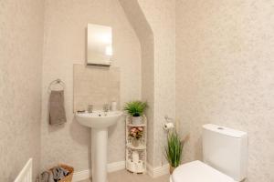 a bathroom with a white sink and a toilet at Clitheroe Wilson Retreat. Central Lancashire in Clitheroe