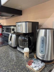 a kitchen counter with a coffee maker and a microwave at Private - Spacious with Jacuzzi and Great Location in Mississauga