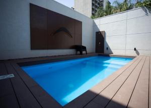 a large blue swimming pool next to a building at casita de tucuman ayacucho in San Miguel de Tucumán