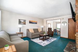 a living room with a couch and a table at Cozy Smoky Mountain Escape w/ Private Deck & Community Pool in Pigeon Forge