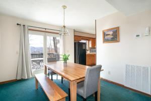 a dining room with a wooden table and chairs at Cozy Smoky Mountain Escape w/ Private Deck & Community Pool in Pigeon Forge