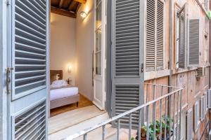 Postel nebo postele na pokoji v ubytování Amelie Suite Trevi