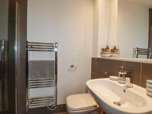 a bathroom with a sink and a toilet and a shower at Crantock Reach in Newquay +22 photos