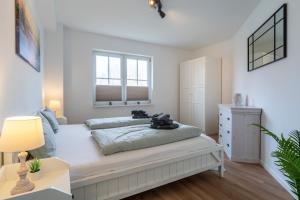 une chambre avec un grand lit et une fenêtre dans l'établissement Ferienwohnung Four Twee – Ihr gemütlicher Rückzugsort in SPO, à Sankt Peter-Ording
