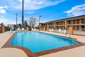 a swimming pool in front of a building at Best Western Greenville Inn in Greenville