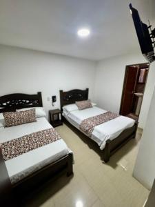 Rúm í herbergi á Hotel Tucan Pereira