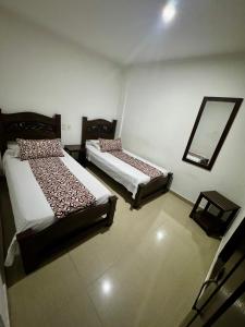 Rúm í herbergi á Hotel Tucan Pereira