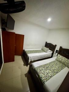 Rúm í herbergi á Hotel Tucan Pereira