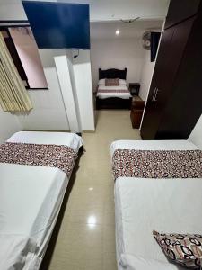 Rúm í herbergi á Hotel Tucan Pereira