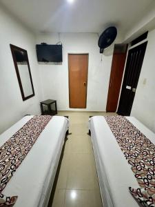 Rúm í herbergi á Hotel Tucan Pereira