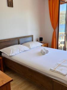 a bedroom with a large bed with two towels on it at Beachfront Apartment Mery, Kneže in Račišće