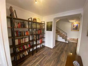 a hallway with book shelves filled with books at Umberto primo rooms in Castelbuono