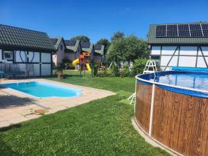 a swimming pool in the yard of a house at Ośrodek domków letniskowych Sztorm in Chłopy