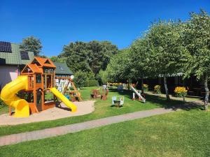 a park with a playground with a slide at Ośrodek domków letniskowych Sztorm in Chłopy