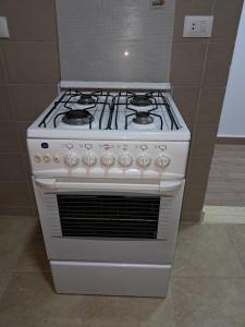 a white stove top oven in a kitchen at New Cairo Cozy Studio استديو فندقى بالتجمع in New cairo