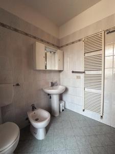 a bathroom with a toilet and a sink at Dullos' House in Lido Adriano +19 photos