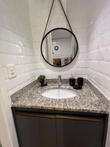 a bathroom with a sink and a mirror at Travellar Spot 12 in Ribeirão Preto +23 photos