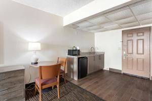 a living room with a table and a kitchen at Americana Motor Inn on Boardwalk in Ocean City
