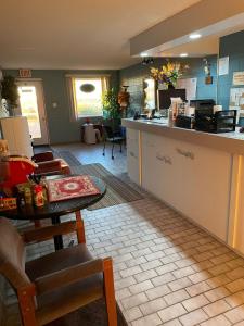 a kitchen with a counter and a table and chairs at Earlton Motel in Earlton +8 photos