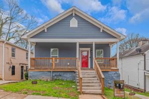a gray house with a deck and a red door at Chic 4BR Home Near AUC&DTWN Attractions in Atlanta