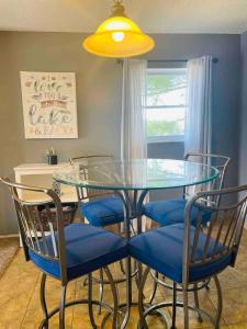a dining room table with blue chairs and a yellow light at Lakeview Lookout in Lake Ozark