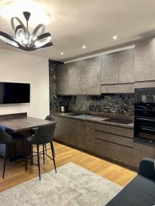 a kitchen with a table and a dining room at Magic Place Bergamo! Beauty Nest Apartment in the heart of the city in Bergamo