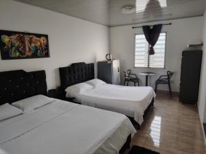 Voodi või voodid majutusasutuse Hotel Palmari toas