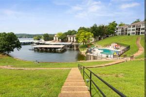 ausable resort with a dock and a body of water at Lakeview Retreat By Wet Feet Retreats in Lake Ozark