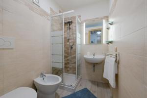 a bathroom with a toilet and a sink and a shower at Maison Antica - One Step Away From the Sea in Maiori +11 photos