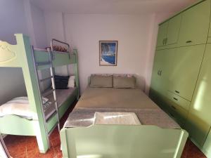 a small bedroom with a bunk bed and a ladder at Vistamar Apartment in Golem