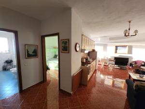 a living room with a kitchen and a dining room at Vistamar Apartment in Golem +11 photos