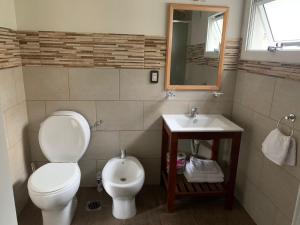 a bathroom with a toilet and a sink at Departamento barrio Once II in Villa La Angostura