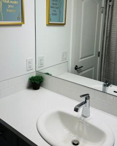 a bathroom counter with a sink and a mirror at Private Very Spacious 2 bed 1-Bedroom basement Suite SW Calgary in Calgary