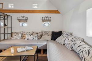 a living room with a couch covered in blankets at Cozy Holiday Apartment On Rømø in Vesterhede