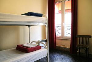 a room with two bunk beds and a window at Aloha Hostel Eiffel Tower by Hiphophostels in Paris